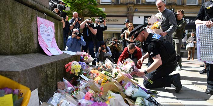 Flowers and letters of condolence laid out in a Manchester street