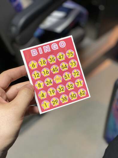 Tour guide Michiko holding up Bingo cards