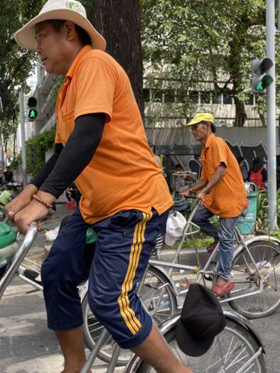 Cyclo riders wearing orange shirts