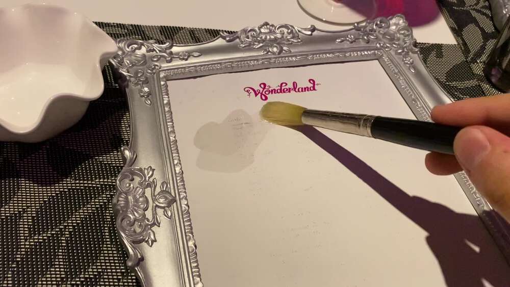 Revealing the Wonderland menu by painting water onto it