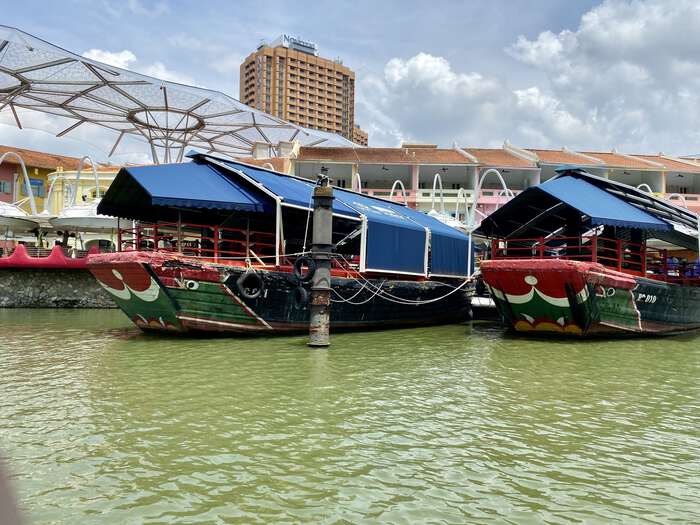 Brightly painted junks moored along the river bank