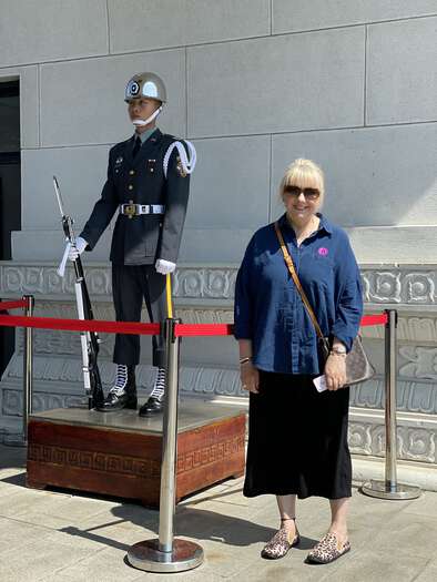 Julijana standing next to a ceremonial guard at the Martyr’s Shrine