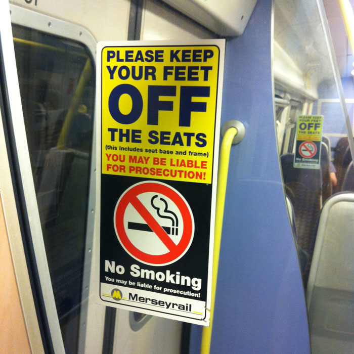 A Merseyrail sign warning customers to keep their feet off seats and refrain from smoking