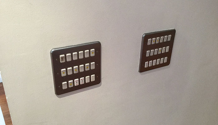 Two panels of switches on a wall