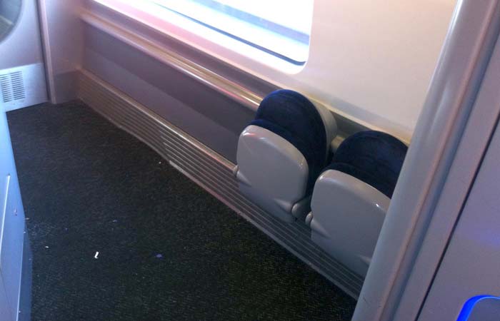 Folded seats in the Coach D corridor, on a Virgin Pendolino train